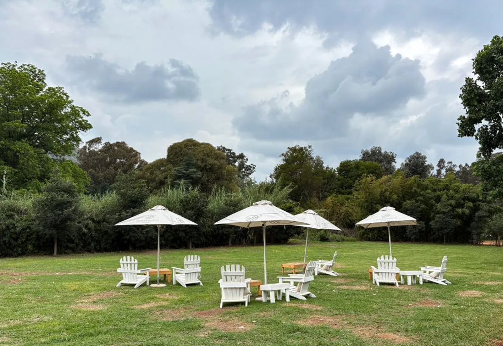 Chairs set in a circle on the grass among the garden beds