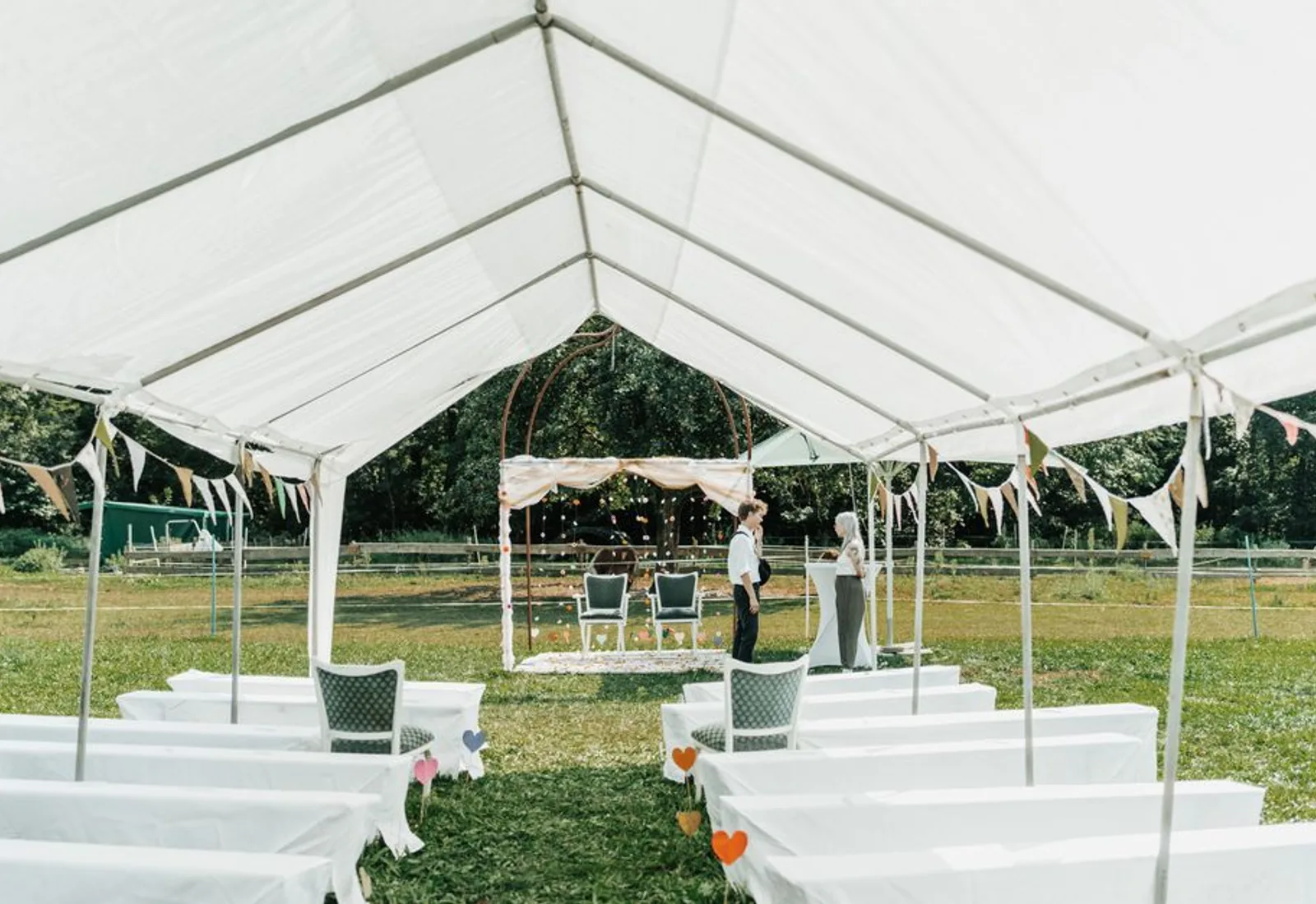 The tent at the end of the night, lights low over empty chairs