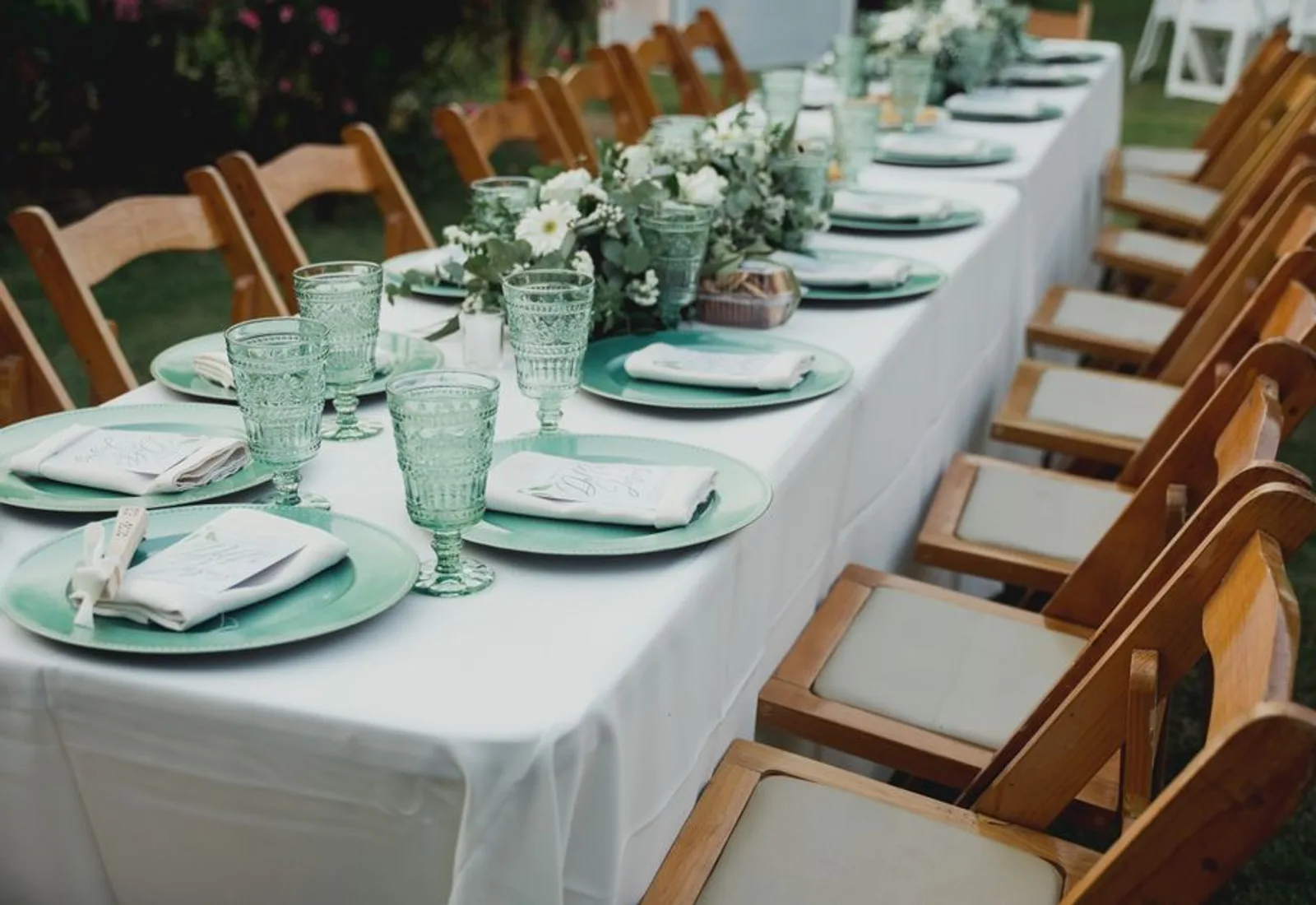 The dining porch set for dinner in golden-hour light