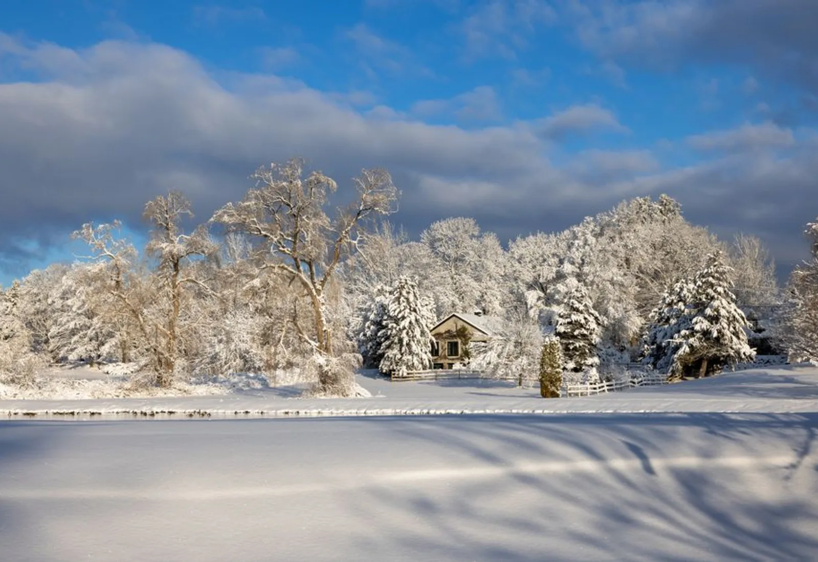 Snow over the roofline of the house in flat winter light